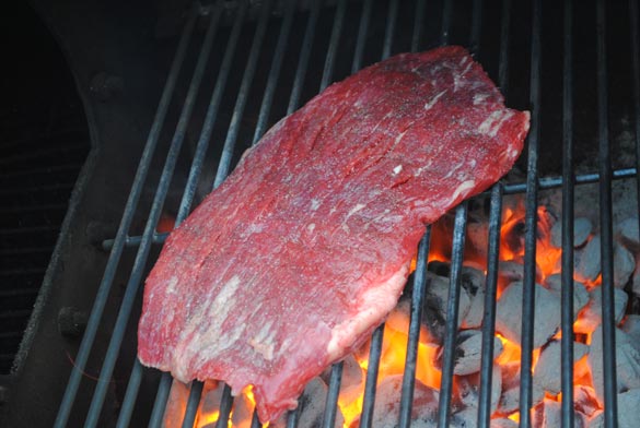 raw steak on grill