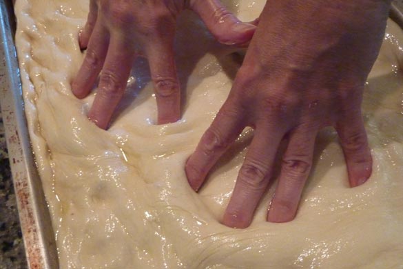 poking focaccia dough