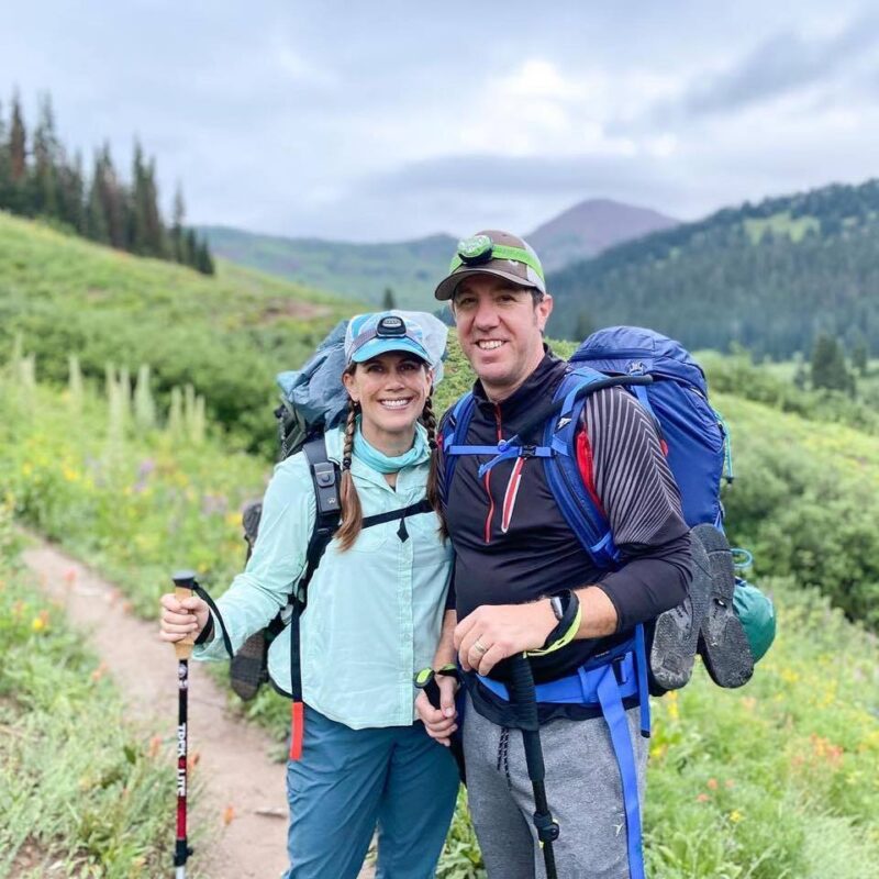 hikers smiling in the mountains